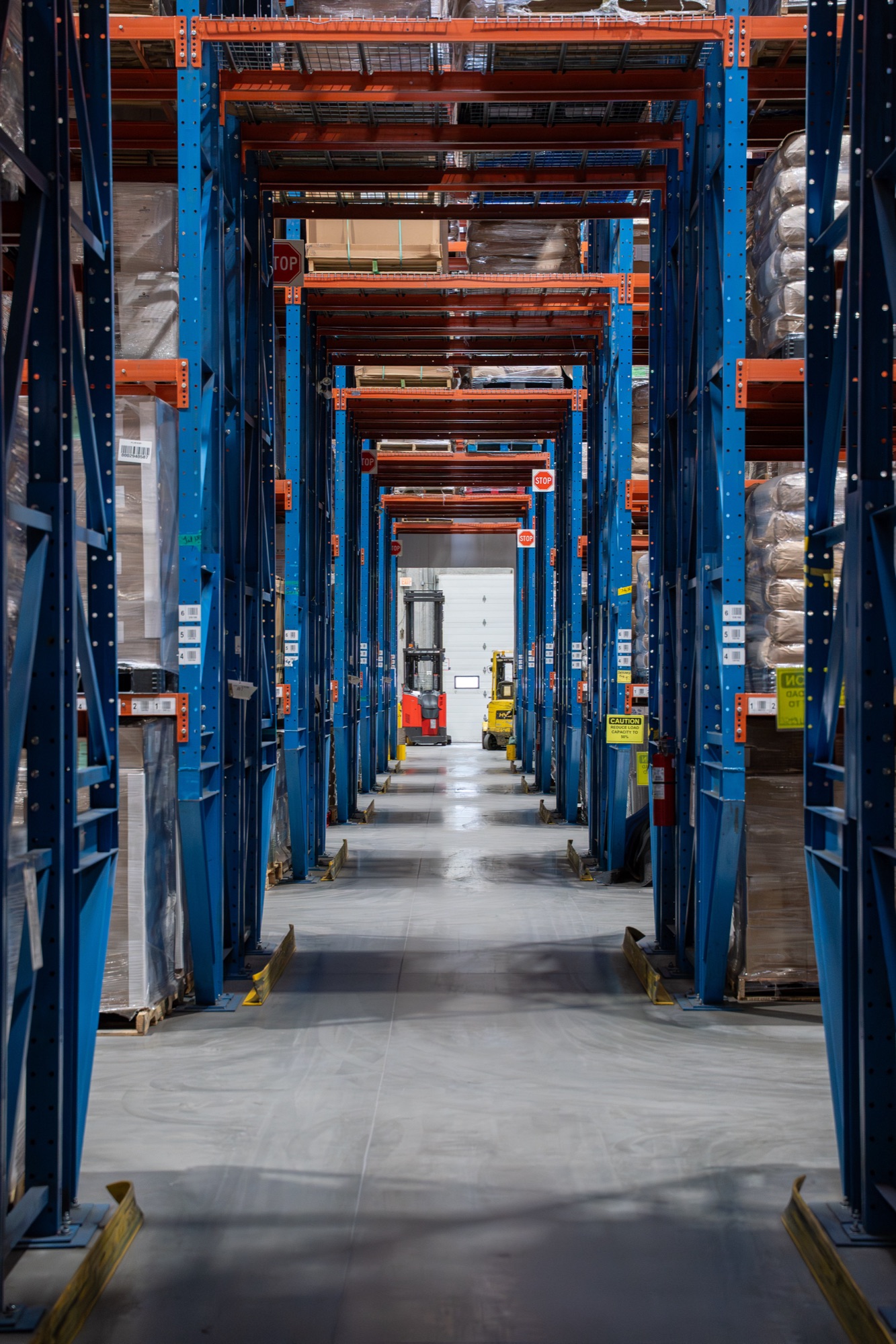 Pallet racking aisle receding into the facility